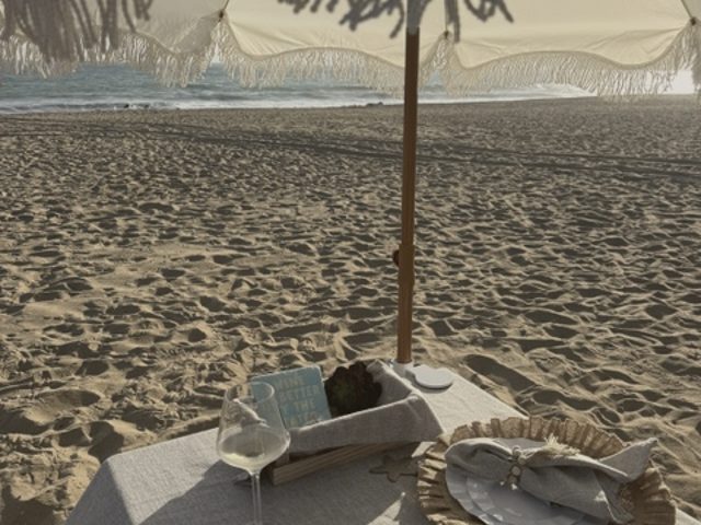 Umbrella and a set table on the sand