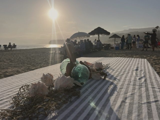 Picnic blankets at golden hour, guests in the distance