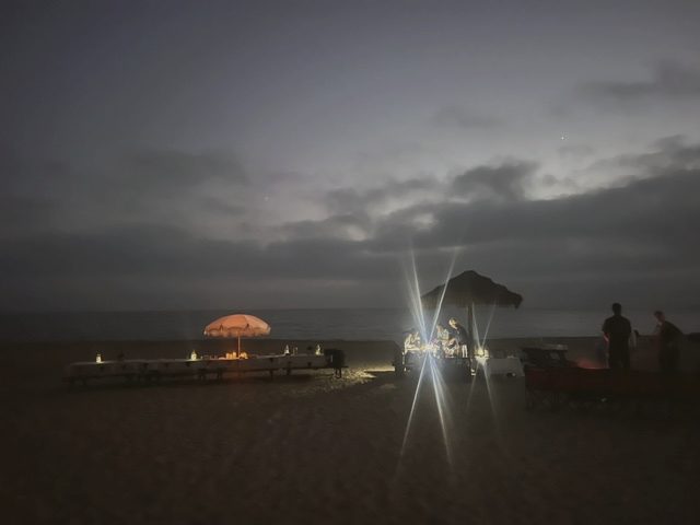 Lanterns along the beach at twilight